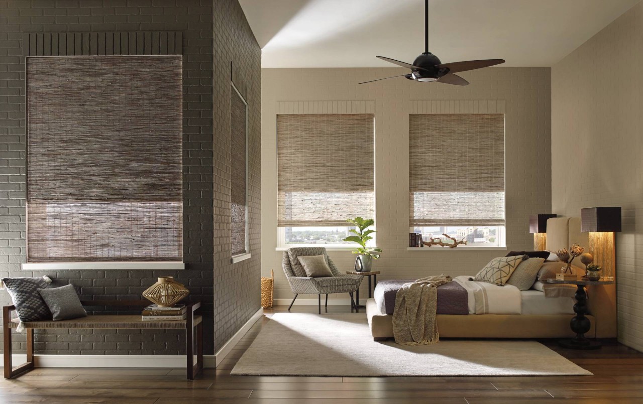 Apartment Bedroom decorated with neutral colored Provenance® Woven Wood Shades from Hunter Douglas near Laredo, TX