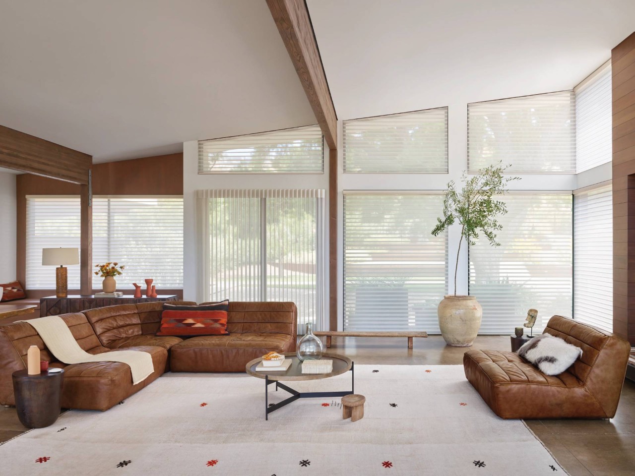 Bright home living room with leather furniture and Hunter Douglas Silhouette® Sheer Shades on the windows near Laredo, TX