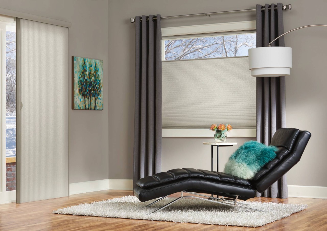 gray-painted sitting room with a leather lounge chair and Hunter Douglas Duette® Cellular Shades